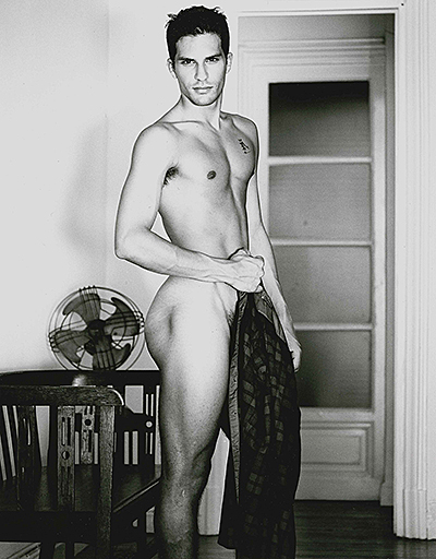 Man standing next to fan