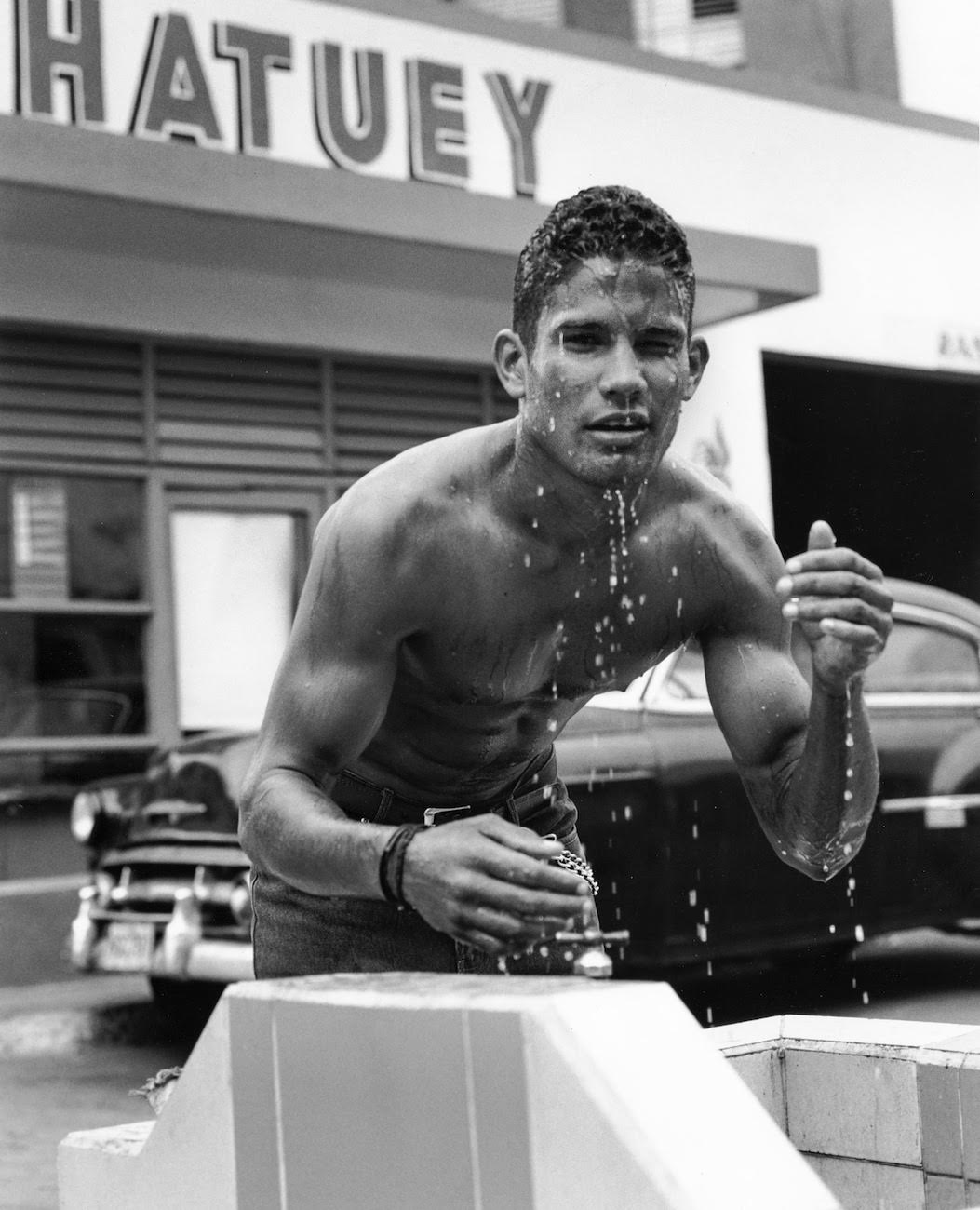 Young man by water fountain